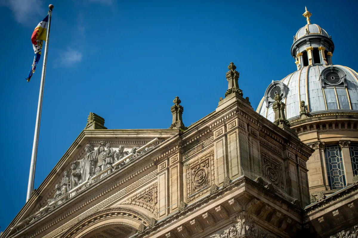 Detailed view of historic architecture in Birmingham, UK, under a clear blue sky.
